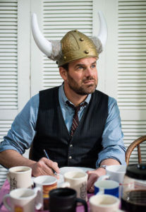 Grant Faulkner wearing a horned helmet writing