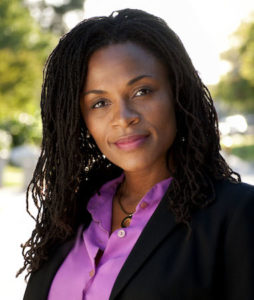 Portrait photo of Reise Moore smiling in an outdoor area
